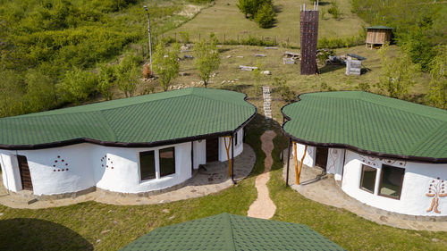 High angle view of houses amidst trees and buildings