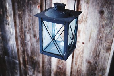 Low angle view of electric lamp hanging on wall
