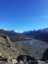 Scenic view of mountains against clear blue sky