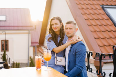 Beautiful couple in love is sitting at a table in an outdoor cafe on a date person