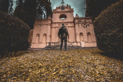 Statue against trees and building during autumn