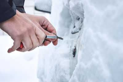 Close-up of hand holding snow