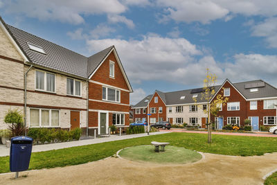 Houses on field against sky