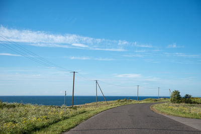 Empty coastal road against sky