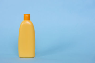 Close-up of bottle against blue background