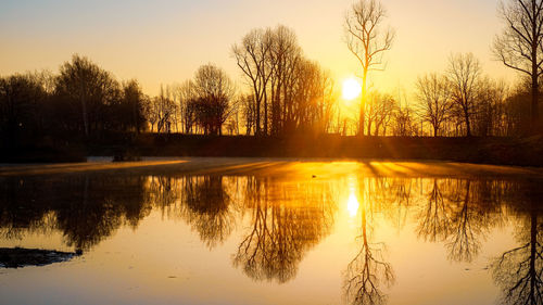 Scenic view of lake against sky during sunset