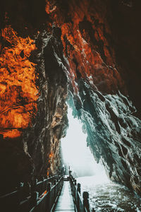 Low angle view of footpath under cave