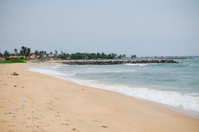 Scenic view of beach against clear sky