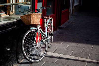 Bicycle parked against brick wall