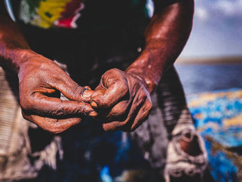 Close-up of hand holding sea against blurred background