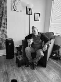 Portrait of man sitting on sofa at home