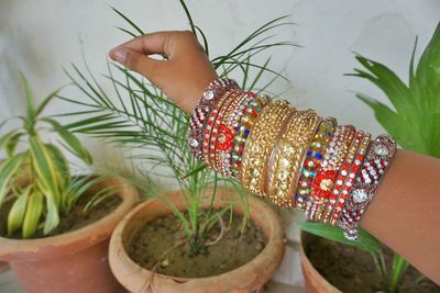 Close-up of hand wearing multi colored bangles