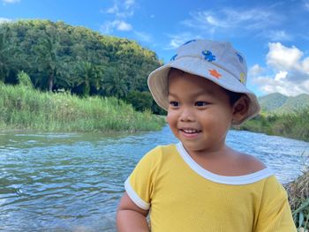 Portrait of cute girl looking at lake