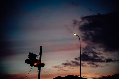 Low angle view of illuminated street light against sky at sunset