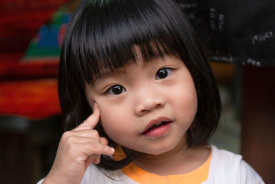 Portrait of cute girl drooling at home