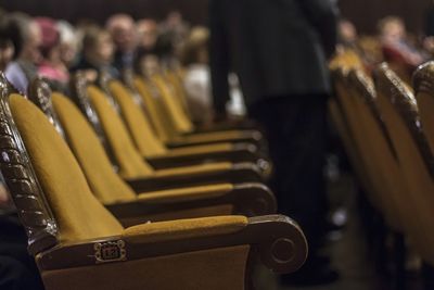 Close-up of yellow chairs in theater