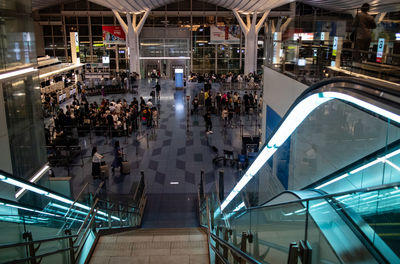 High angle view of people walking on escalator in city