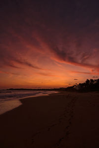 Scenic view of beach against sky during sunset