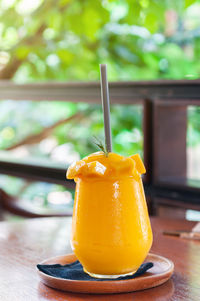 Close-up of orange juice on table