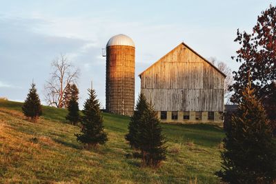 Barn on field against sky