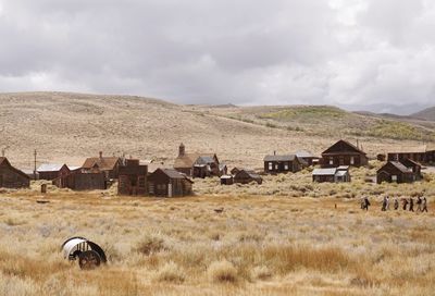 Houses on landscape against sky