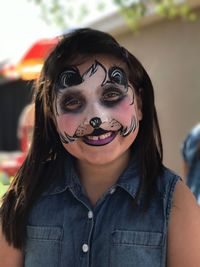 Close-up portrait of smiling girl with face paint