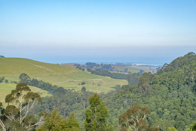High angle view of landscape and sea against clear sky