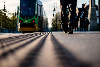 Surface level of man walking by tramway