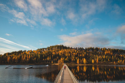 Autumn sunset at lake syvajarvi, in hyrynsalmi, finland. a young man in a plaid red and black shirt