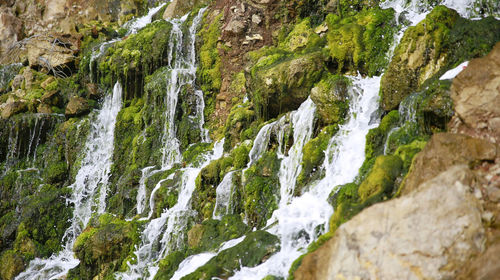 Scenic view of waterfall on mountain