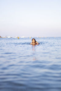 Portrait of girl swimming in sea