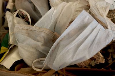 High angle view of white rose hanging on shoes