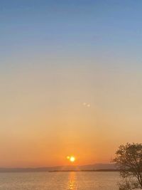 Scenic view of sea against clear sky during sunset