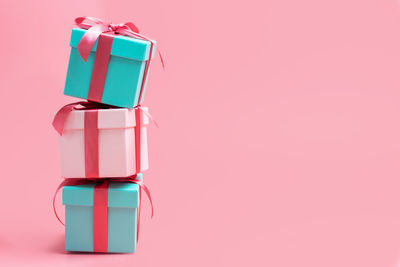 Stack of pink box against blue background