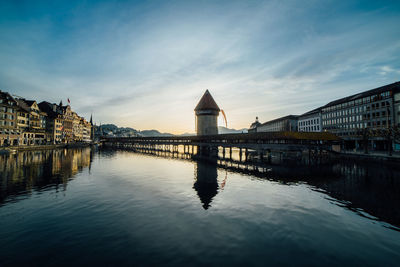 Bridge over river with buildings in background