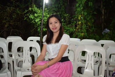 Portrait of young woman sitting outdoors