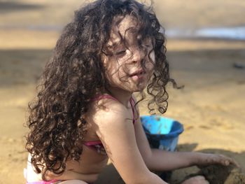 Portrait of woman with girl on beach