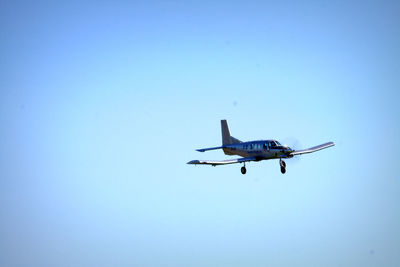 Low angle view of airplane flying in sky
