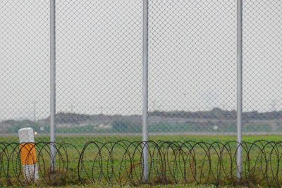 Field seen through chainlink fence