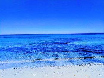 Scenic view of sea against clear blue sky