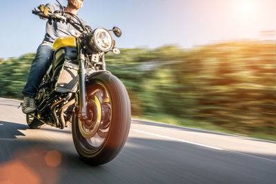 Blurred motion of person riding bicycle on road