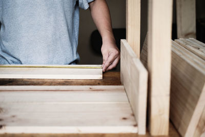 Midsection of man working on table