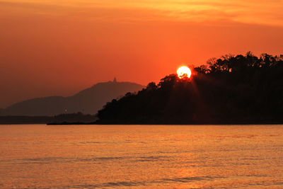 Scenic view of sea against romantic sky at sunset