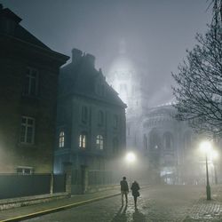 People in illuminated city at night