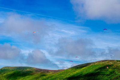 Low angle view of hot air balloon flying over landscape