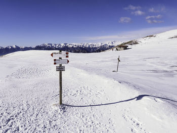 Scenic view of snow covered field against sky