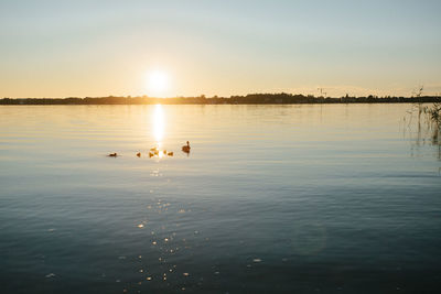 Scenic view of lake against sky during sunset