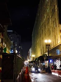 Illuminated street lights in city at night