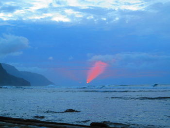 Scenic view of sea against rainbow in sky