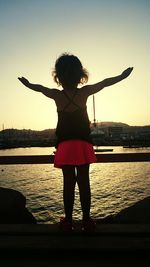 Silhouette of woman standing in water